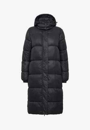 Black puffer coat with a hood, featuring a long, oversized design, quilted texture, and snap-button closure. Accented with elastic cuffs.