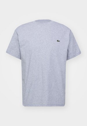 Hall hall t-särk, millel on ümmargune kaelus, lühikesed varrukad ja väike roheline logo vasakul rinnal. Tagaküljel on lihtne disain.