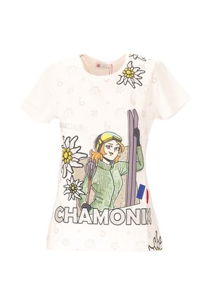 T-shirt bianco in cotone con una grafica di uno sciatore in abbigliamento verde, fiori e il testo "CHAMONIX" con un accento della bandiera francese.