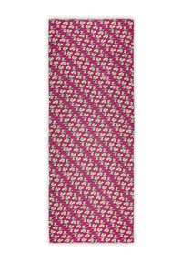 Tissu à motifs présentant un fond magenta avec des formes abstraites et des détails en crème répétés, offrant une apparence texturée.
