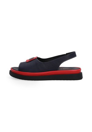 Navy leather slingback sandals feature a red sole, open toe design, and a decorative button accent on the front. Flat rubber outsole.