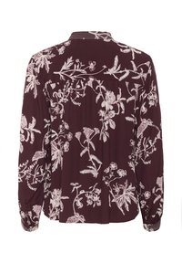 Burgunderfärgad blus med lång ärm och detaljerad vit blommönstring, med en bakfåll och knapppaneler på ärmarna.