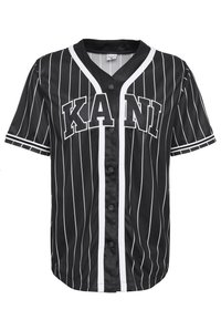 Černo-bíle pruhovaný baseballový dres s krátkými rukávy, se zapínáním na knoflíky a grafickým textem "KANI" na přední straně. Texturovaná tkanina.