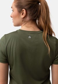 Olivgrünes Sportshirt aus strukturiertem Stoff; mit kurzen Ärmeln und einem runden Ausschnitt; Logodetail auf der Rückseite nahe dem Kragen.