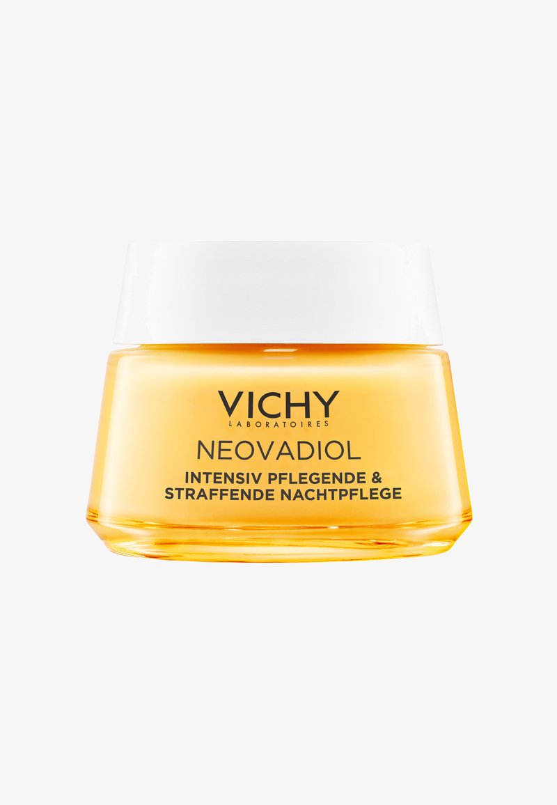 Glass jar with a transparent orange-yellow body and a white lid. Text on the jar indicates it is Vichy Neovadiol night cream.