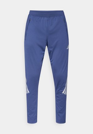 Blauwe sportbroek met een rekbare tailleband, zijritszakken en witte diagonale strepen aan de zijkanten. Gemaakt van een glad en lichtgewicht materiaal.