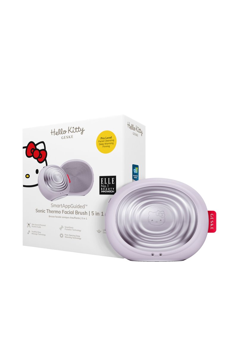 Sonisk ansiktsborste med en texturerad lavendelutsida och silverinredning, med en Hello Kitty-design och röd tag. Förpackningen innehåller varumärkesinformation och funktioner.