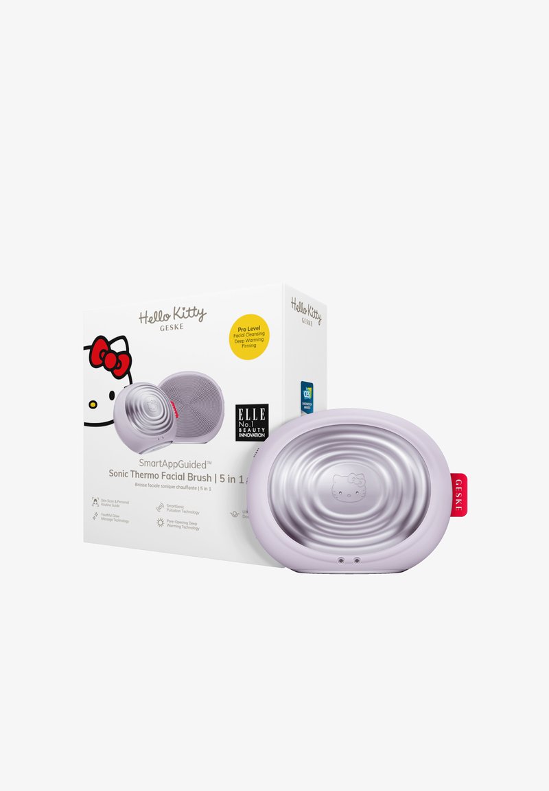 Sonisk ansiktsborste med en texturerad lavendelutsida och silverinredning, med en Hello Kitty-design och röd tag. Förpackningen innehåller varumärkesinformation och funktioner.