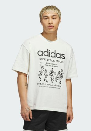White cotton t-shirt featuring black graphic print of basketball players, “adidas” logo, and text details. Short sleeves, crew neck design.