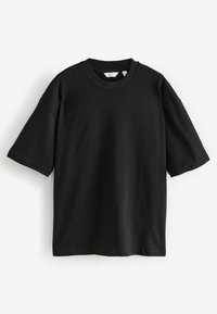 Sort oversized t-shirt med korte ærmer lavet af bomuld. Rund halsudskæring, syede manchetter og en lige kant uden synlige mønstre eller design.