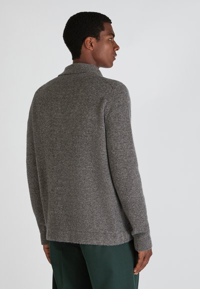 Grau woller Cardigan mit einem kragenförmigen Ausschnitt, strukturiertem Stoff und einem leicht lockeren Schnitt. Er verfügt über lange Ärmel und einen Saum, der unter der Taille endet.