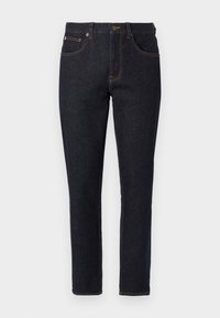 Tmavomodré slim-fit džínsy s prednými vreckami, pútkami na opasok a oranžovým prešívaním na jednofarebnom pozadí.