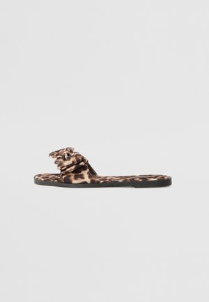 Slip-in sandal med leopardprint og stofoverdel med flæsedetaljer, flad sort sål og glat tekstur. Velegnet til afslappet brug.