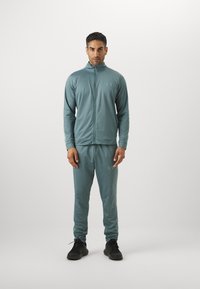 Under Armour RIVAL KNIT - Tracksuit - jasper blue/serpentine