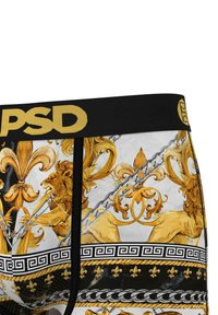 Cinturilla negra con el logo dorado "PSD". Presenta intrincados patrones de leones amarillos y florales sobre un fondo blanco y negro.