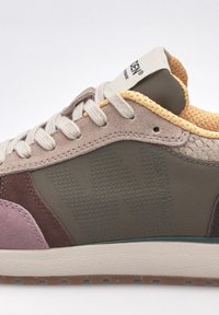 Sneaker with a mix of materials, featuring gray suede, olive green synthetic overlays, yellow mesh accent, and a textured rubber sole.