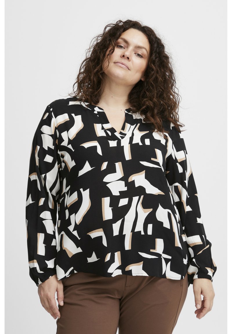 Blusa nera con un motivo geometrico astratto in bianco e beige. Presenta una scollatura a V e maniche lunghe con polsini elasticizzati.
