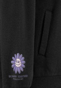 Black fabric with a graphic of a smiling flower in purple and white, accompanied by the text "BE HAPPY TOGETHER WITH POSITIVE VIBES."