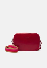 Red leather crossbody bag with a rectangular shape, featuring a logo, a zip closure, and a multicolored striped fabric strap.