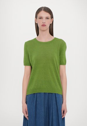 Short-sleeve green knit sweater with a round neckline, soft texture, and ribbed hem, paired with a blue pleated skirt.