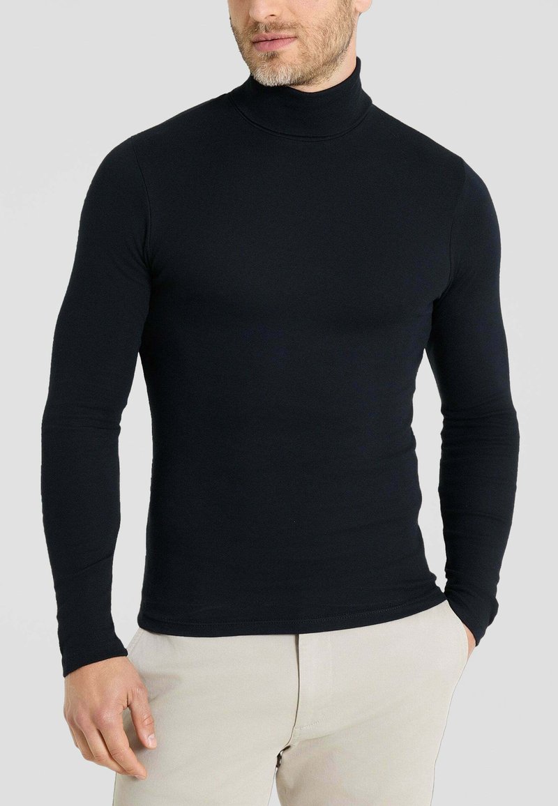 Maglia a collo alto nera realizzata in un tessuto liscio e elasticizzato. Maniche lunghe e design aderente, con colletto alto e senza motivi visibili.