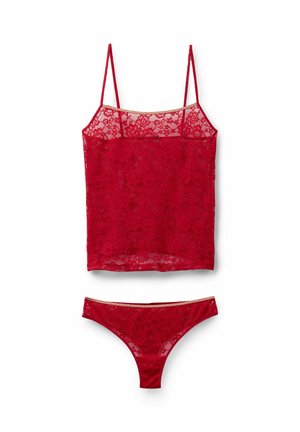 Red lace camisole with spaghetti straps, paired with matching lace thong. Features floral pattern and a subtly shimmery waistband on thong.