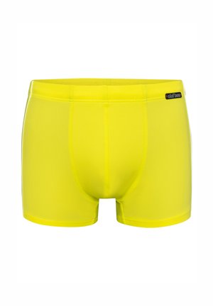 Hellegelbe Herren-Badehose mit figurbetontem Schnitt und "olaf benz"-Etikett am Bund.