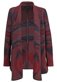 Cardigan à manches longues ouvert en façade avec des motifs tribaux géométriques rouges, noirs et gris, et une bordure foncée sur les manches et l'ourlet avant.