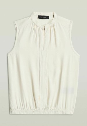 Blusa smanicata color crema con tessuto raccolto al collo e orlo elastico, caratterizzata da una patta frontale con bottoni nascosta e scollo rotondo.