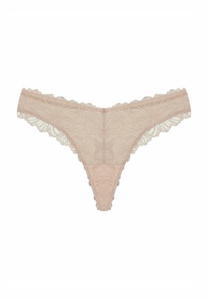 Lace thong in light beige, featuring floral patterns, scalloped edges, and a small decorative metal detail at the center front.