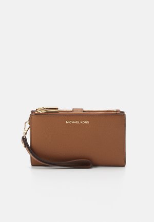 Brown leather wristlet wallet with a textured finish, gold-tone hardware, zip closure, and a removable wrist strap. Features brand logo.