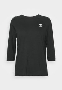 Svart långärmad skjorta med rundad halsringning. Har en liten vit logotyp på bröstet och en subtil textur. Avslappnad passform.