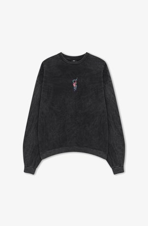 Black crew neck sweatshirt with a textured finish, featuring an embroidered design of a hand and snake in colors of red and blue.