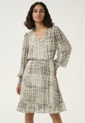 Lightweight dress with a V-neck, long puff sleeves, and a belted waist. Features a gray and cream checkered pattern and ruffled hem.