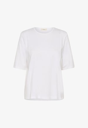 Balta īsroku T-krekls ar apaļu kaklu, redzamām sānu šuvēm un mazu bēša krāsas etiķeti apkakles iekšpusē.