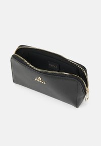 Black leather zippered pouch with gold hardware, featuring a textured surface and a branded interior label. Compact, rectangular design.