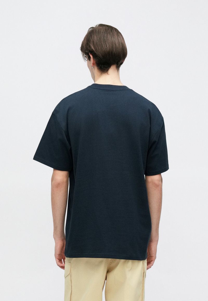 Navy blue t-shirt with a relaxed fit, short sleeves, and a crew neckline. Smooth fabric texture with minimal detailing. Back view.