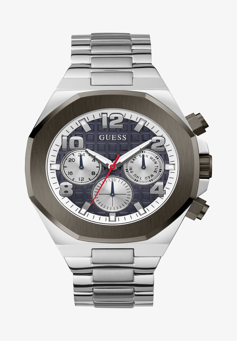 Reloj de acero inoxidable plateado con caja octogonal, esfera texturada de color azul oscuro, subesferas blancas y plateadas, y acentos rojos. Presenta una pulsera de metal.