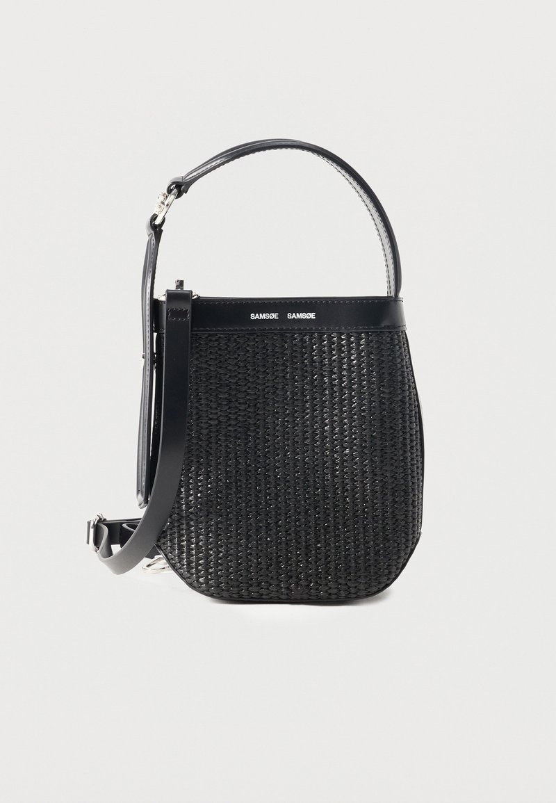 Μαύρη υφαντή τσάντα χειρός με στρογγυλεμένη βάση, δερμάτινες λεπτομέρειες, ρυθμιζόμενο ιμάντα ώμου και λογότυπο της μάρκας Samsøe Samsøe στη κορυφαία ταινία.