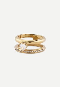 Gold-tone ring set featuring a heart-shaped clear stone and a band adorned with small clear crystals, both with a polished finish.
