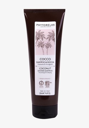 Tube marron foncé de shampooing douche à la noix de coco Phytorelax, étiqueté végan et biologique, 250 ml, fabriqué en Italie, avec des illustrations de palmiers.