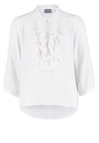 Blouse blanche à manches longues avec devant en dentelle froncée, boutons recouverts de tissu et petit col à volants.