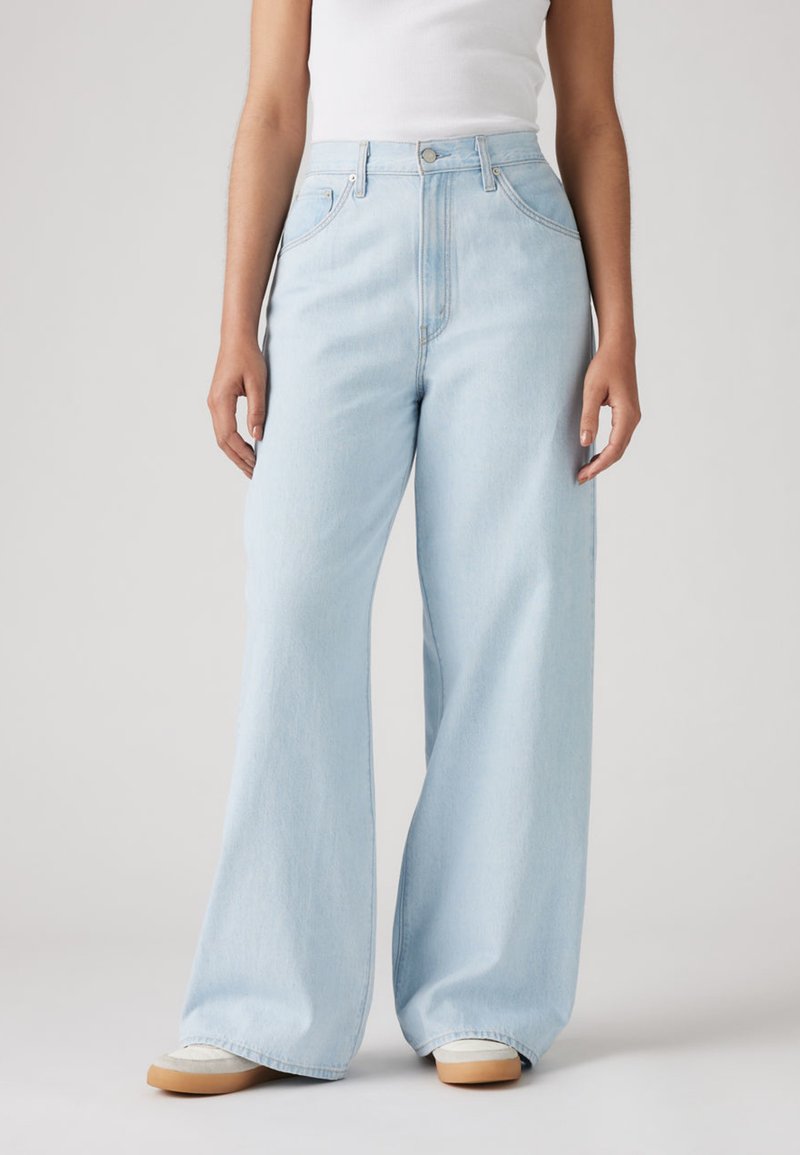 Light blue wide-leg jeans made from denim, featuring a high waist, front pockets, and a clean finish with subtle stitching.