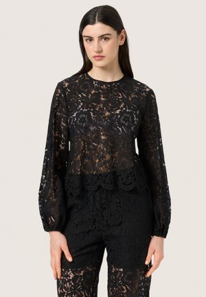 Black lace long-sleeve top featuring a scalloped hem and floral pattern, layered over a matching black lace bottom, semi-transparent texture.