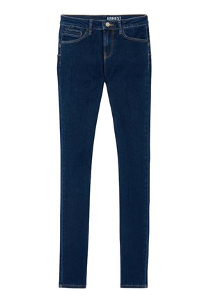Jeans en denim bleu foncé au design ajusté, dotés de cinq poches et de coutures dorées contrastantes le long des coutures. Texture lisse, taille mi-haute.