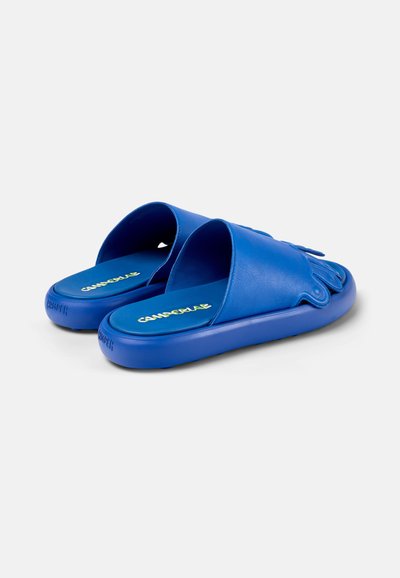 Sandali blu con un finish opaco e liscio, design open toe, accenti rialzati e suola testurizzata. Logo stampato sulla soletta.