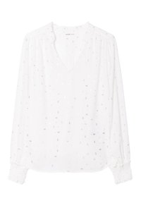 Blouse blanche à manches longues et décolleté en V, ornée de petites embellissements en argent et de poignets froncés avec des détails de smocks.