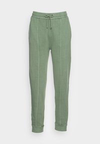 Pantalones de chándal verde claro, hechos de una tela suave, que cuentan con una cintura elástica con cordón ajustable y piernas estrechas con puños en los tobillos.
