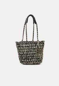 Woven tote bag in black and cream, featuring chain-link handles and a textured finish. Includes a small charm detail on the side.