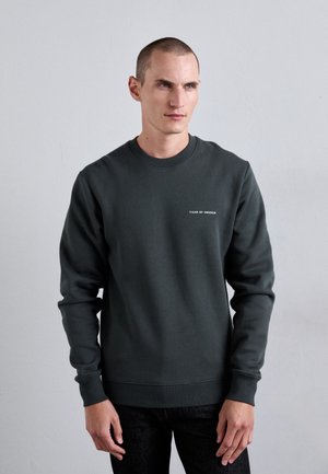 Dark green sweatshirt in cotton blend, featuring a crew neckline, long sleeves, and minimalistic white logo embroidery. Smooth texture.